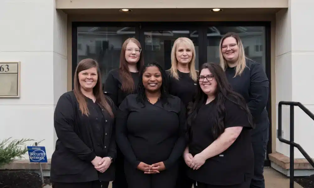 Staff in front of office entry
