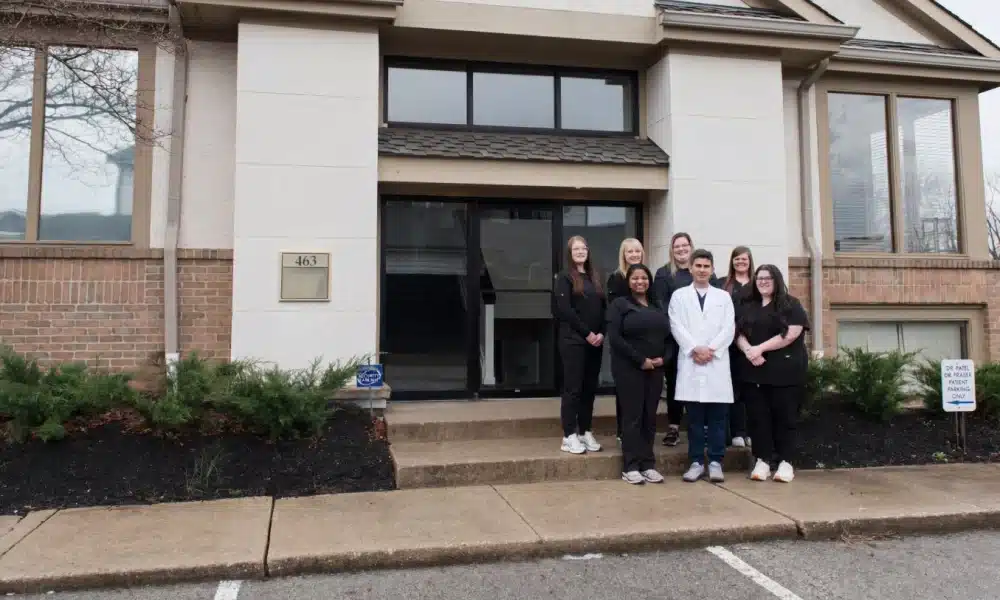 Team in front of office entry