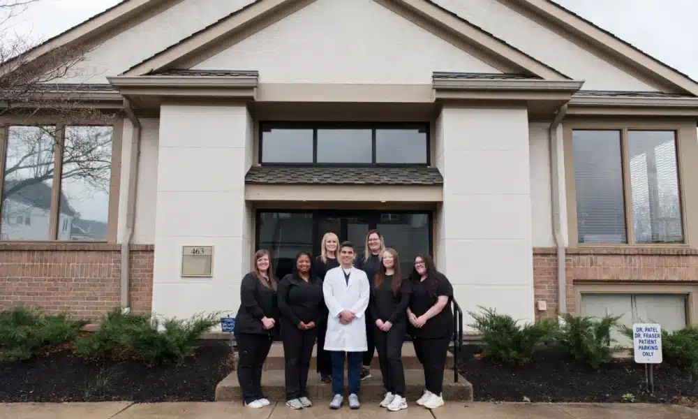 Team in front of office entry